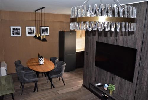 a dining room with a table and a television at Casa Nuova in Kotor