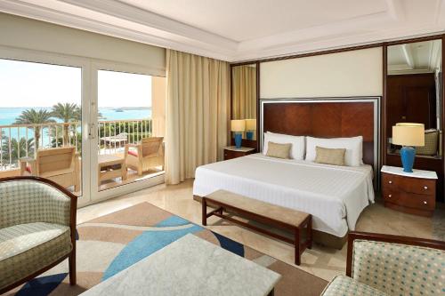 a hotel room with a bed and a balcony at Hurghada Marriott Beach Resort in Hurghada