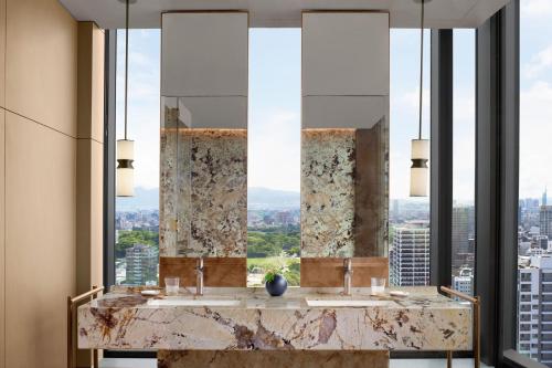 a bathroom with two sinks and a large window at The Ritz-Carlton Fukuoka in Fukuoka