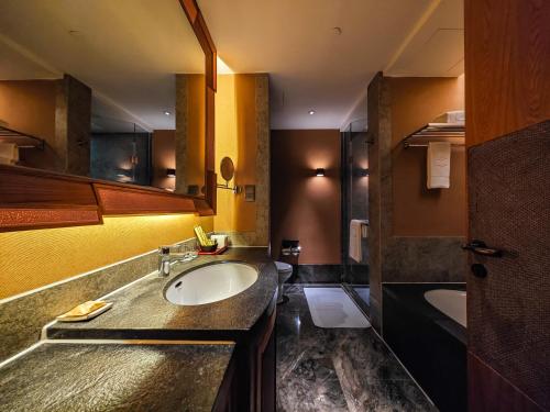 a bathroom with a sink and a tub at Shangri-La Resort Shangri-La in Shangri-La