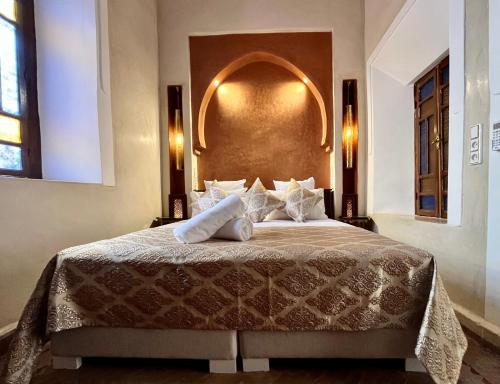 a bedroom with a large bed in a room at Riad Dar Zaouia in Marrakech
