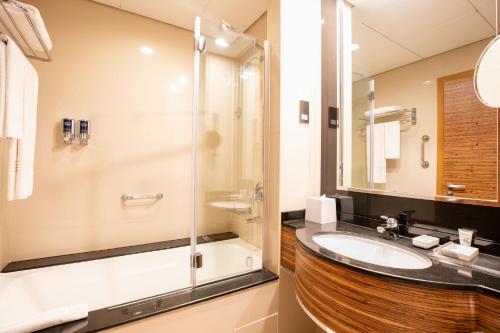a bathroom with a sink and a shower at Four Points by Sheraton Bur Dubai in Dubai