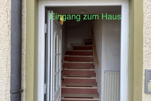 a stairway leading into a building with a sign on it at Semi-Detached House on 2 Floors in Giengen an der Brenz