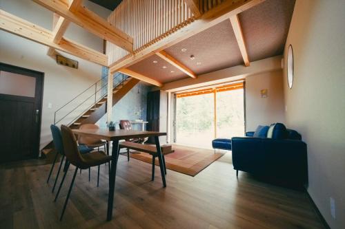 a living room with a table and chairs and a couch at Private Villa ietona in Fujikawaguchiko
