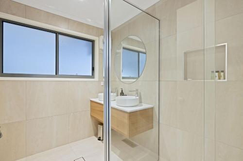 a bathroom with a sink and a glass shower at The Island's Treasure in Cowes