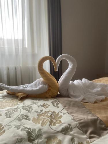two swans making a heart on a bed at Hotel Sonne in Weingarten