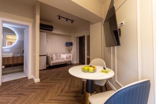 a room with a table and chairs and a living room at Calea Floreasca 77 Aparthotel 1 in Bucharest