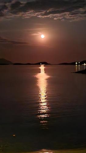 a sunset over a large body of water at Gianni's Apartment By The Sea in Ammouliani