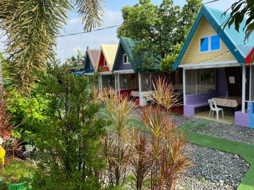 a colorful house with a garden in front of it at Villa Leonida Resort in Bugallon