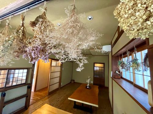 鐮倉的住宿－古民家の宿 鎌倉楽庵 - Kamakura Rakuan -，配有桌子和吊灯的房间