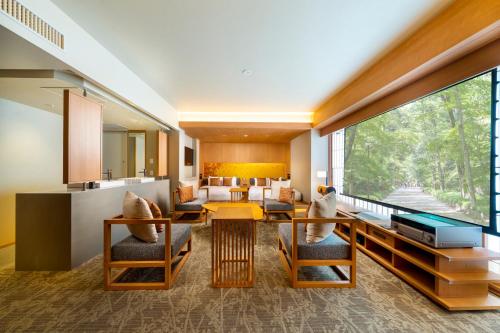 a living room with a table and chairs at KAYA Kyoto Nijo Castle, BW Signature Collection by Best Western in Kyoto