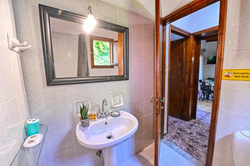 a bathroom with a sink and a mirror and a toilet at Villas Vista Del Mar in Kissamos
