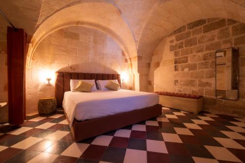 a bedroom with a bed and a checkered floor at le CASINE di MARUGGIO 19 in Maruggio