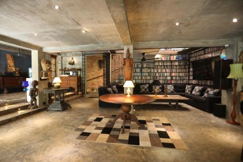 a living room with a table and a checkered floor at Aayu Hanthana Boutique Hotel in Kandy