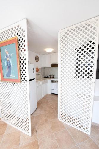 a kitchen with a white door in a room at Traditional House under the Clock Tower with Sweet View in Poros