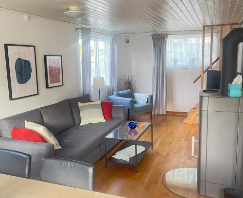 a living room with a couch and a table at Lovely Waterfront Cottage near Karlshamn in Asarum