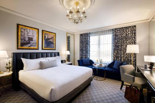 a hotel room with a bed and a chandelier at Hotel Carmichael, Autograph Collection in Carmel