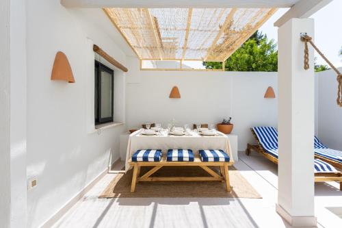 a dining room with a table and a skylight at Esencia Marbella Casas Boutique in Estepona