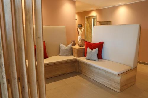 a room with two benches with pillows on them at Hotel Rebenhof in Baden-Baden