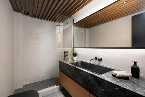 a bathroom with a black sink and a mirror at La Torretta Suites & Spa in Pirgos