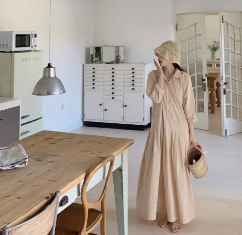 a woman standing next to a table in a kitchen at Maison de Clare in Gyeongju