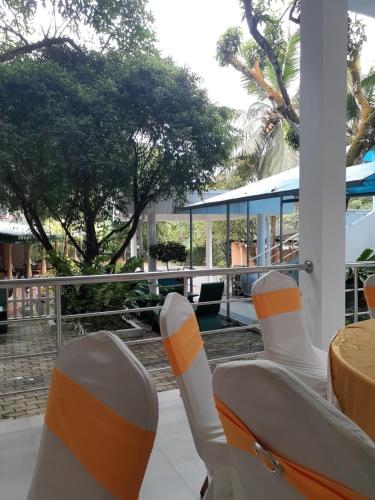 a group of chairs sitting on a patio at Hotel Kintop in Udugama