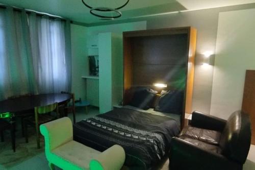 a bedroom with a bed and a chair and a couch at Calm & New_Epinay-Le Bourget in Épinay-sur-Seine