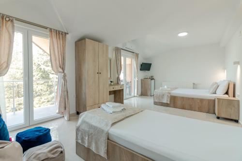 a bedroom with two beds and a large window at DE & EV ACCOMMODATION in Ohrid