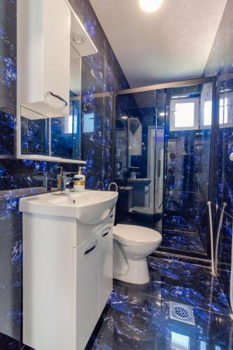 a bathroom with a sink and a toilet and a shower at DE & EV ACCOMMODATION in Ohrid