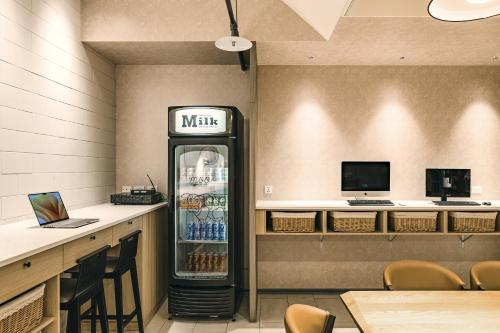 a drink refrigerator in a restaurant with a counter at Orange Hotel - Ximen, Taipei in Taipei