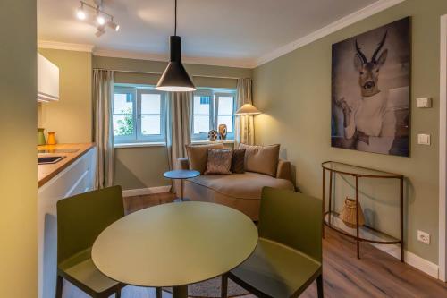 a living room with a table and a couch at Villa Wickenburg in Salzburg