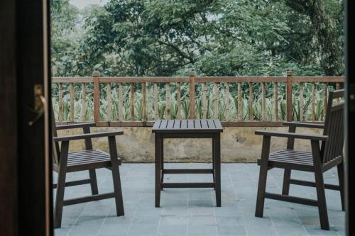 two benches and a table and two chairs on a patio at Amour Resort Bavi in Hanoi