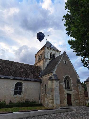 a church with a balloon on top of it at gite Chezelle in Saint-Georges-sur-Cher