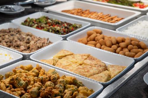 a buffet of different types of food in trays at Prestige Goya Park in Roses