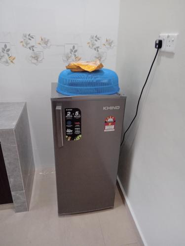 a trash can with a blue lid on top of it at HOMESTAY CIK PHIA in Kuala Terengganu