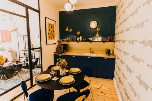 a kitchen and dining room with a table and chairs at Apartament Przemyśl, ul. Rynek 7 in Przemyśl