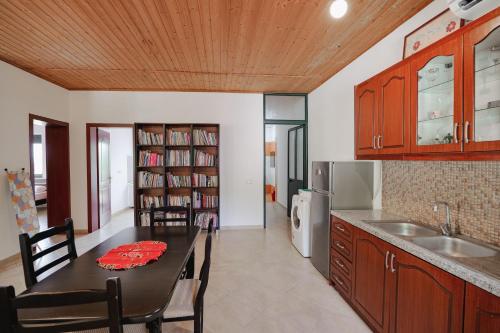 a kitchen with a table and a dining room at Green Villa in Sarandë