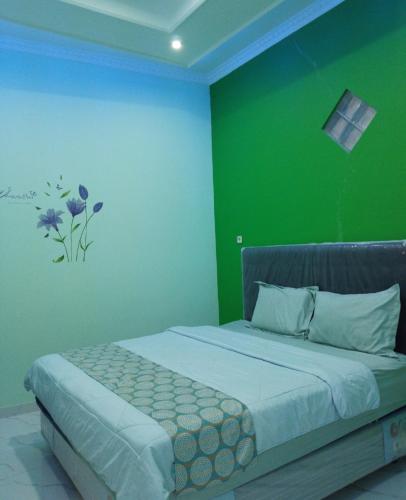 Кровать или кровати в номере Villa Rumah Kita