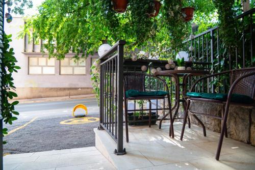a balcony with a table and chairs next to a street at La Guardia apartment with free private parking in Rijeka
