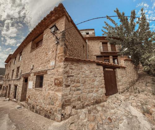 a stone building with a door on the side of it at La Casa de la Acacia in Olba