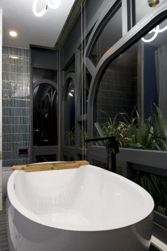 a bath tub in a bathroom with plants at The Palette Dalat in Da Lat