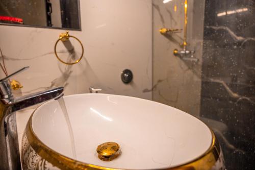 a bathroom with a white sink and a shower at Ronne's ZED Penthouse and apartment in Arpora