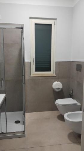 a bathroom with a shower and a toilet and a sink at B&B Tenuta San Michele in Capaccio-Paestum