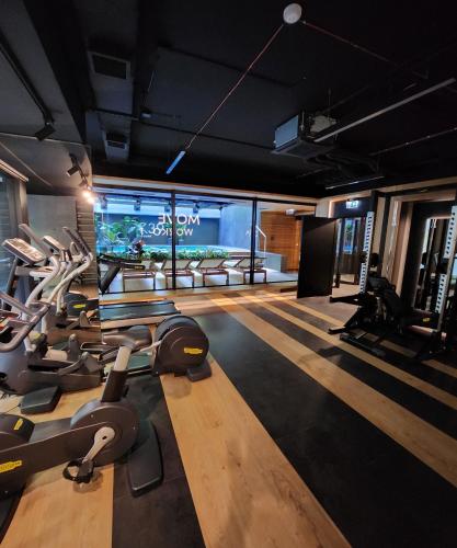 a gym with several treadmills and a fish tank at Luxury Vistula Old Town Apartments , hammock on the terrace, free parking! in Krakow