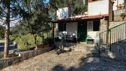 a house with a porch with a tree in front of it at Casa vacanze Alfano in Ascea