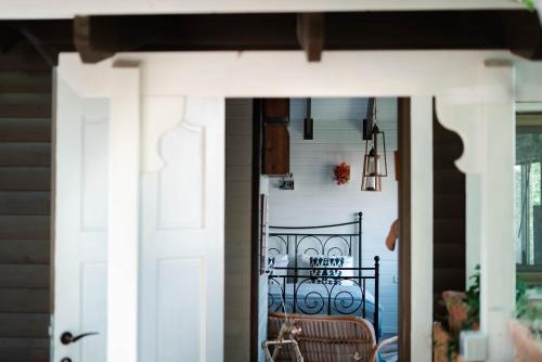 a door leading to a porch with a chair at Live in the woods in Mikhmannim
