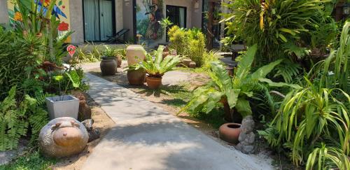 a garden with a bunch of plants in a yard at Marin' s Home in Thalang