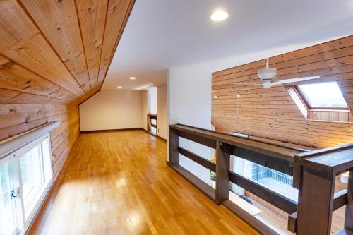 an empty living room with a wooden wall at Villa Noël Hakone Fuji Sauna&Open Air Bath in Hakone