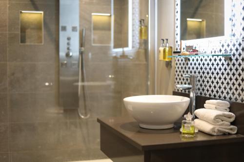 a bathroom with a sink and a shower at Killarney Oaks Hotel in Killarney
