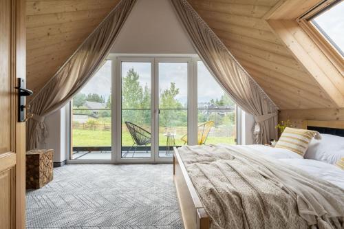 En eller flere senge i et værelse på Rychlinowe Domki